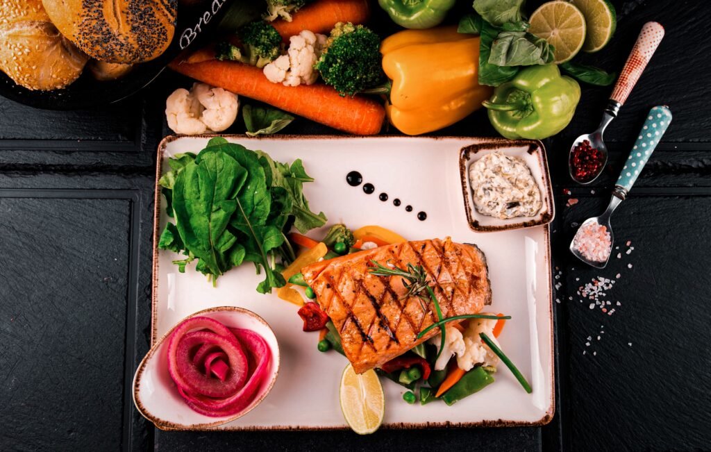Grilled salmon with leafy greens and vegetables — foods that support hearing health