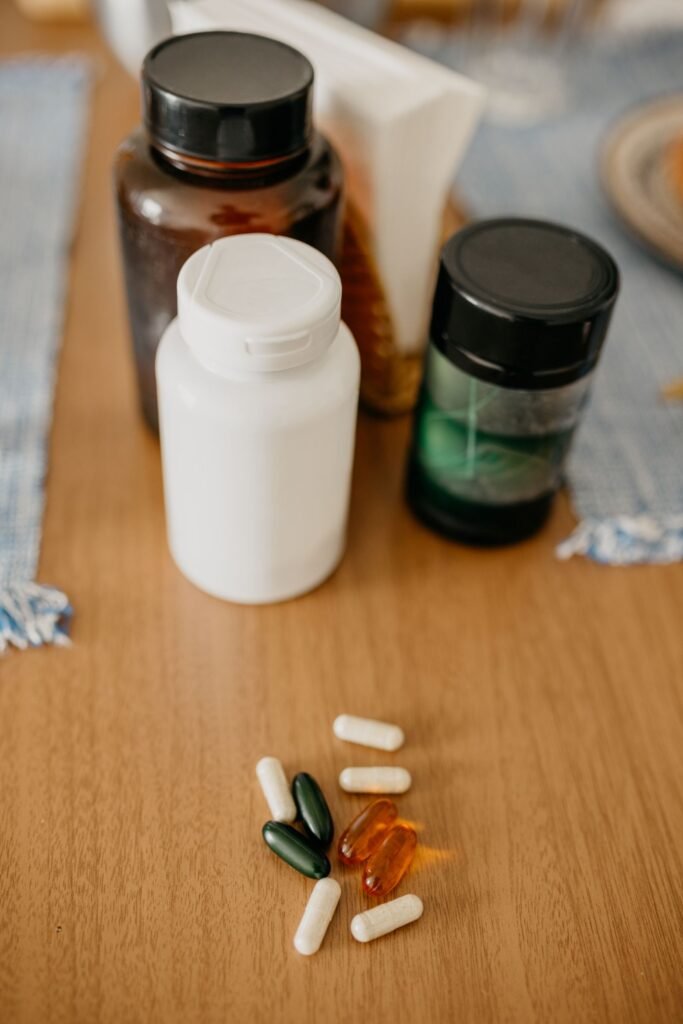 Supplement capsules and vitamins on a wooden table