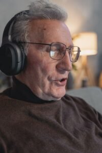 Senior man wearing headphones for tinnitus sound therapy