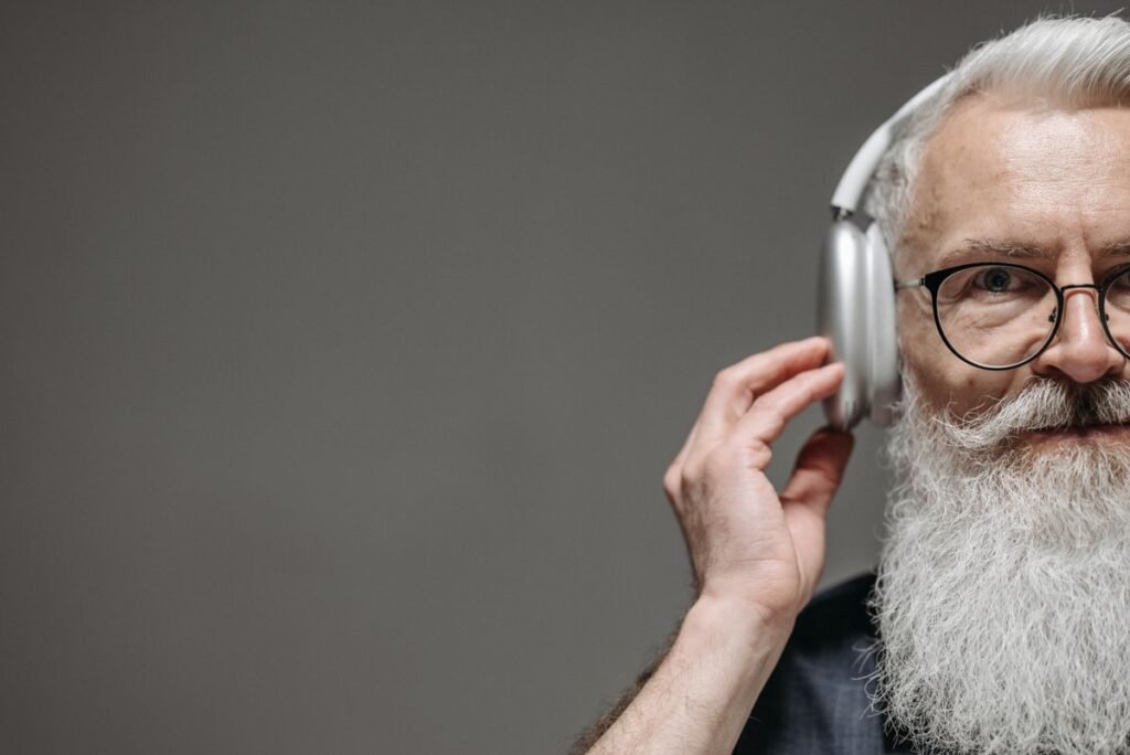 Senior man wearing headphones listening to music