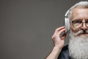 Senior man wearing headphones listening to music