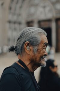 Side profile of a senior man with a hearing aid