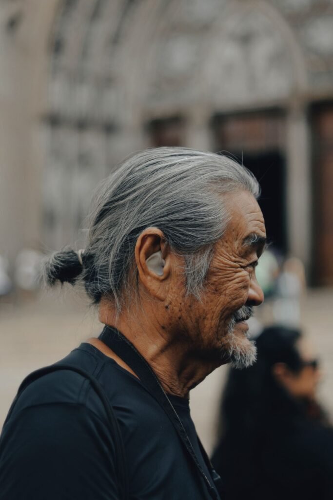 Side profile of a senior man with a hearing aid