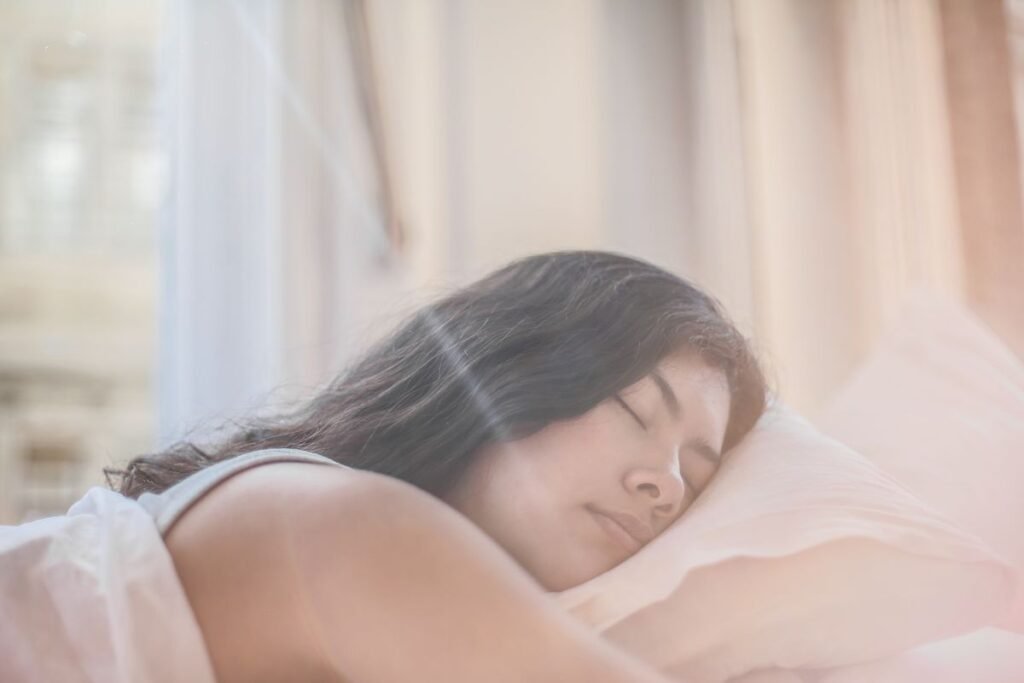 Woman sleeping peacefully in a sunlit bedroom